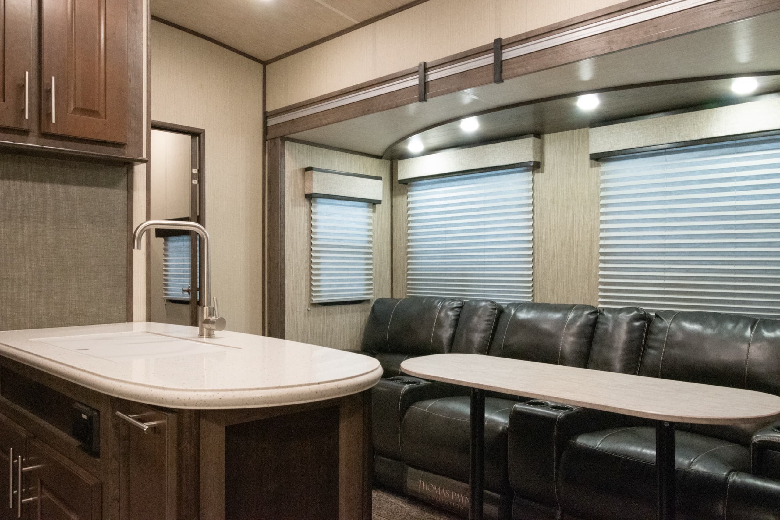 Motorhome galley and dining interior under bright, even lighting