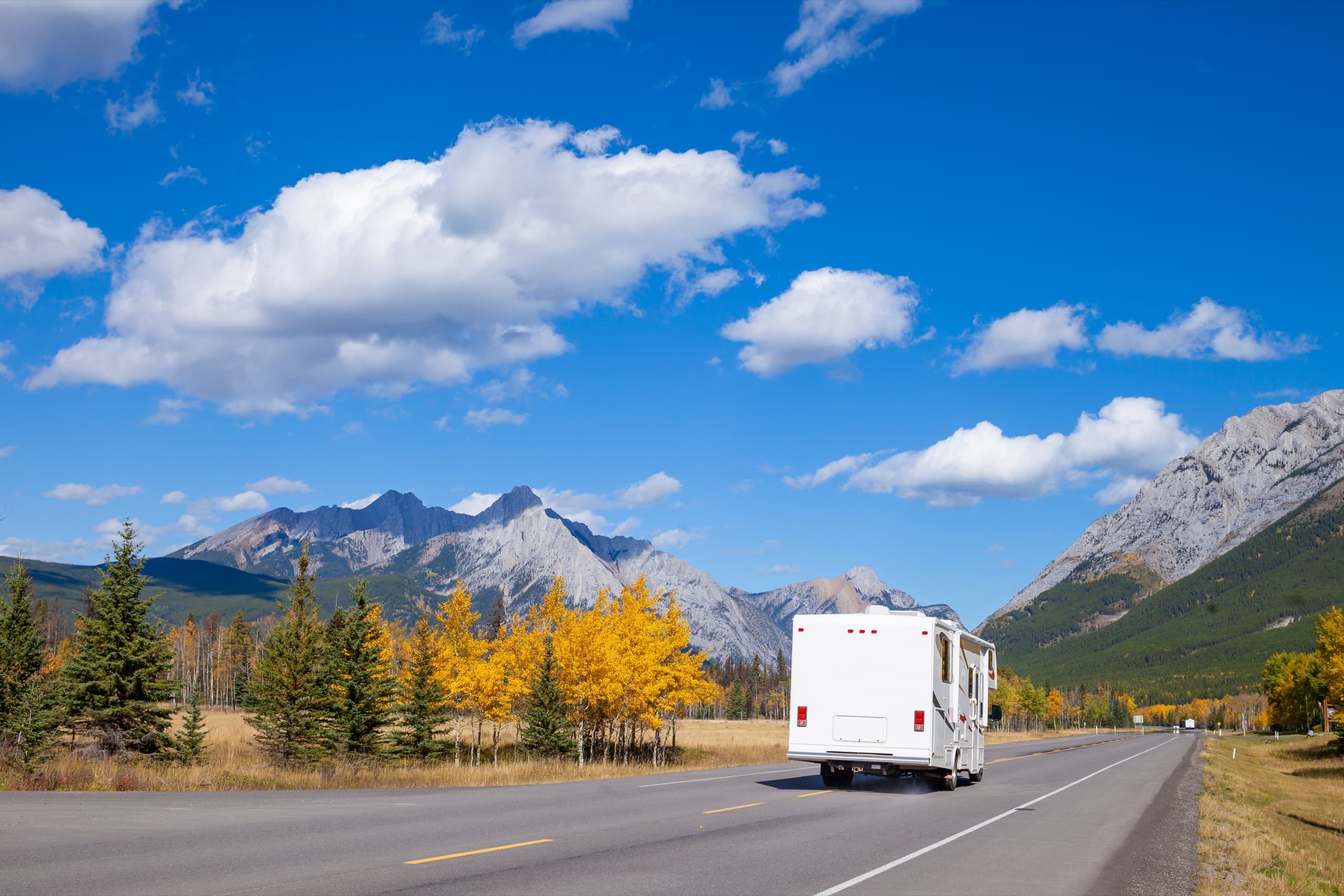 Motorhome travelling an open mountain highway in bright daylight